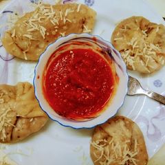 A picture of Cheese  vegetables  Dumplings  With Red Sauce.