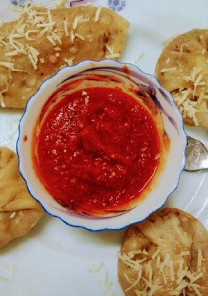 A picture of Cheese vegetables Dumplings With Red Sauce.