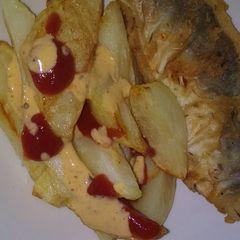 Fried Chips with tomato sauce and chilli sauce A picture of Fried Chips with tomato sauce and chilli sauce.