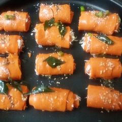 A picture of Cheesy Beetroot khandvi roll.