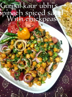 A picture of Spinach spiced salad with chickpeas 🥬🍅🧅.
