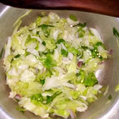 A picture of Steamed cabbages with onions.