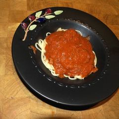 A picture of Shrimp on Pasta with Marinara Sauce.