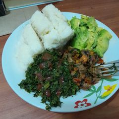 A picture of Kenyan Ugali with Sukuma Wiki and Beef Stew.