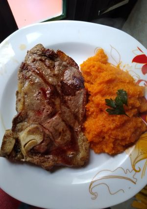 Una foto de Costeleta con puré de calabaza