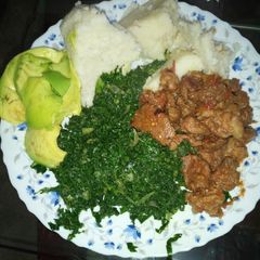 A picture of Ugali sukuma served with mutton and guacamole.