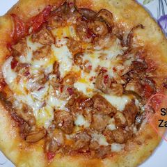 A picture of Chicken Tikka Pizza baked in Pateela.