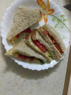 A picture of Bread sandwich (tomato/cucumber).