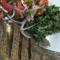 A picture of Fried fish with greens and kachumbari.