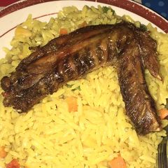 A picture of Fried rice and chicken.