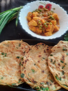 A picture of Green garlic laccha paratha with matar paneer.