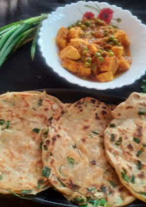 A picture of Green garlic laccha paratha with matar paneer.