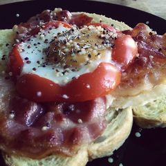 A picture of Egg sunny side up with Red Pepper, Quinoa and Bacon.