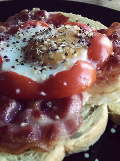A picture of Egg sunny side up with Red Pepper, Quinoa and Bacon.