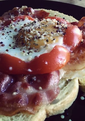 A picture of Egg sunny side up with Red Pepper, Quinoa and Bacon.
