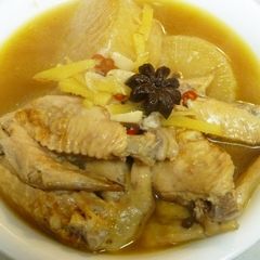 A picture of Chinese-Style Simmered Chicken Wings and Daikon Radish with Star Anise In a Pressure Cooker.