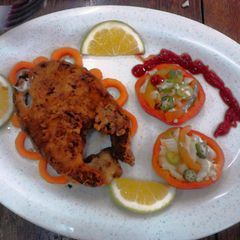 A picture of Garnished Pan fry fish with vegetable salad.