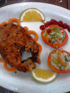 A picture of Garnished Pan fry fish with vegetable salad.