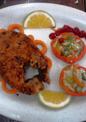 A picture of Garnished Pan fry fish with vegetable salad.
