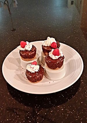 A picture of Chocolate Individual Cheesecakes with a Salted Chocolate Caramel Glaze.