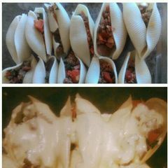 A picture of Jumbo Meat Lover Shells smothered in cheese sauce!.