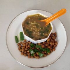 A picture of Chana & green onion soup.