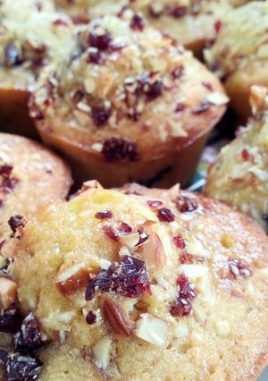 A picture of Orange and Almond Muffins with Orange Almond Syrup and a Almond and cranberry topping.