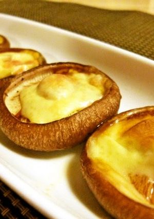 A picture of Shiitake Mushrooms with Melted Cheese.