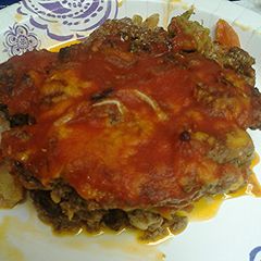 A picture of Vegetables and ground meat pie.