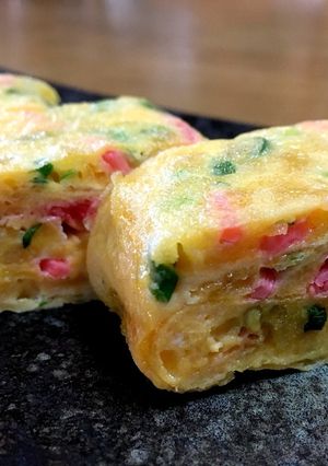 A picture of Tamagoyaki with Pickled Ginger and Scallions.