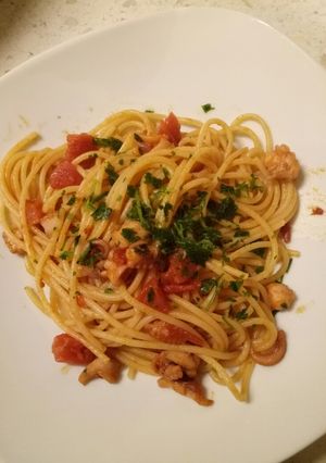 A picture of Spaghetti with octopus and fresh tomato sauce.