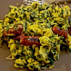 A picture of Scrambled Eggs with Spinach and Grilled Sausage.