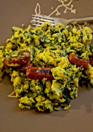 A picture of Scrambled Eggs with Spinach and Grilled Sausage.