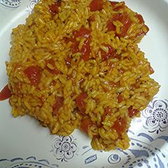 A picture of Herb and spice rice with tomatoes.