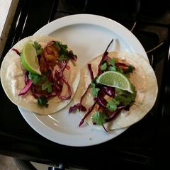 A picture of Shrimp tacos with red cabbage lime slaw.