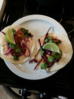 A picture of Shrimp tacos with red cabbage lime slaw.
