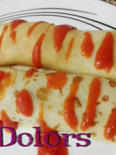 Una foto de Canelones con masa de crêps rellenas de merluza y verduras