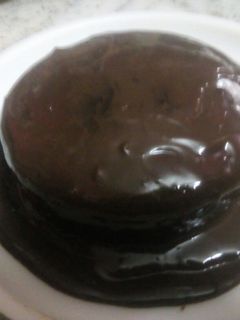 A picture of Chocolate cake with chocolate sauce.