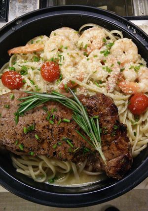 A picture of New York Stop Steak over Shrimp Scampi.