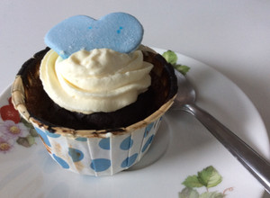 A picture of Chocolate Genoise Sponge Cupcakes with Whipped Cream and Blue Fondant.