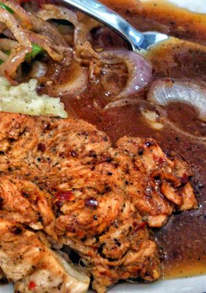 A picture of chicken steak wid brown sauce.