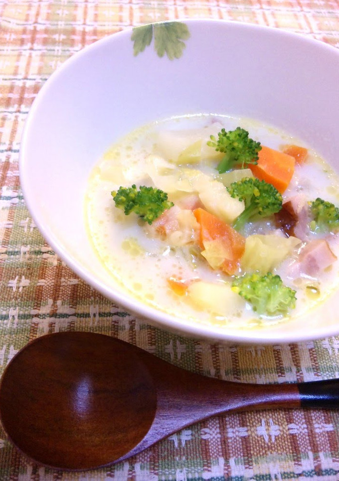 A picture of A chowder full of vegetables with bacon and welsh onions.