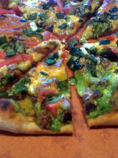 A picture of Left over taco pizza.