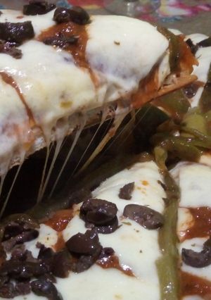 Una foto de Pizza de muzzarella con morrón verde y aceitunas negras