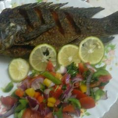 A picture of Fried. Fish with salad.
