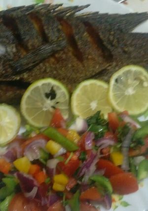 A picture of Fried. Fish with salad.