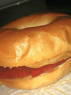 A picture of Sweet Savory Toasted peanut butter and jelly on a mini bagle.