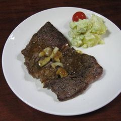 A picture of Beef Steak and Sauce.