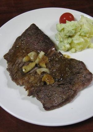 A picture of Beef Steak and Sauce.
