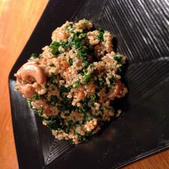 A picture of quinoa and kale salad with cherry lemon vinagrette.